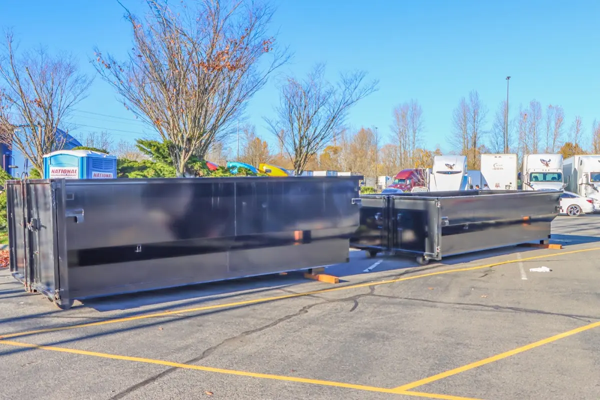 Professional dumpster rental service with roll-off container on residential driveway in Helena Valley West Central